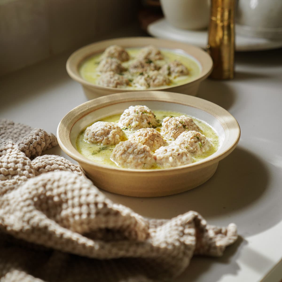 Meatball soup in 2 bowls