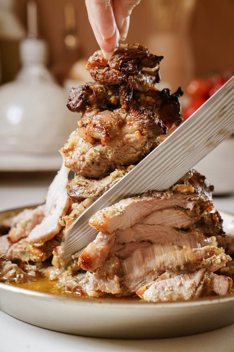Gyro meat being cut with a knife